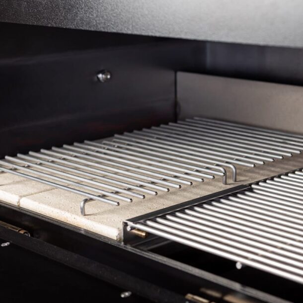 Einbau Hauptgrillrost MERKLINGER“ delstahl-Grillrost im MERKLINGER Holzbackofen, eingesetzt über den Schamotteplatten.“